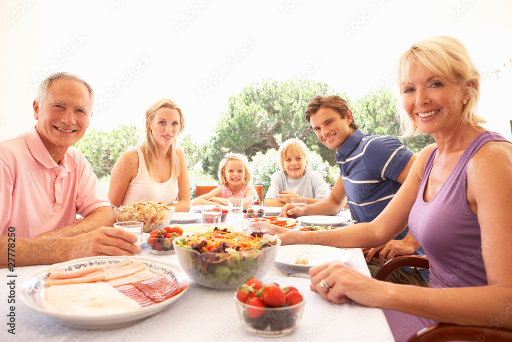 Extended family, parents, grandparents and children, eating outd