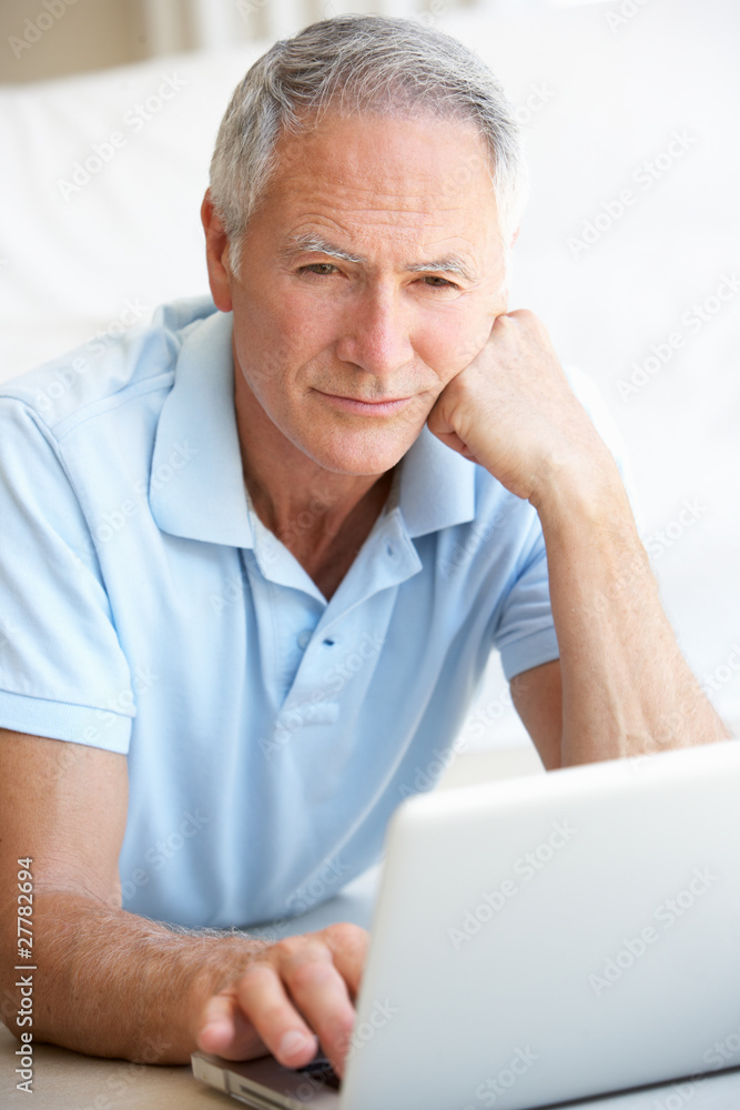 Senior man using laptop computer Senior man using laptop computer