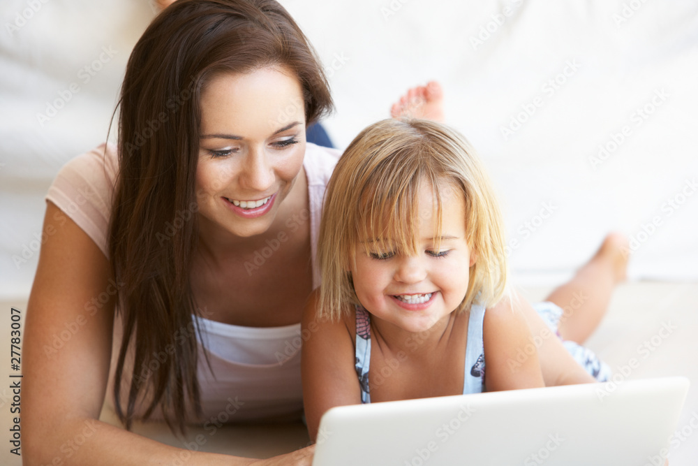 Young woman with girl using laptop computer Young woman with girl using laptop computer