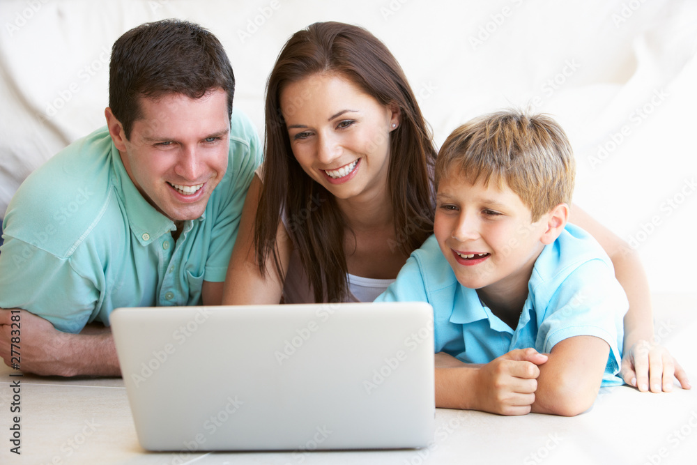 Young parents, with child, on laptop computer Young parents, with child, on laptop computer