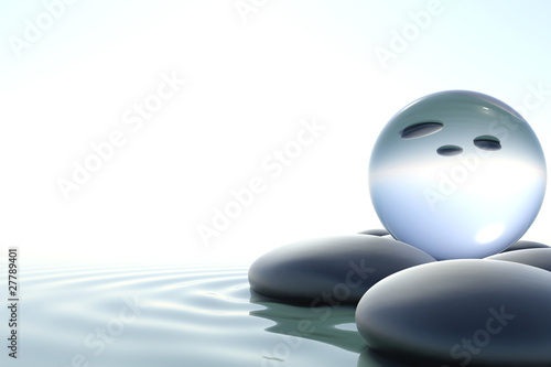 Zen stones and glass sphere on white background