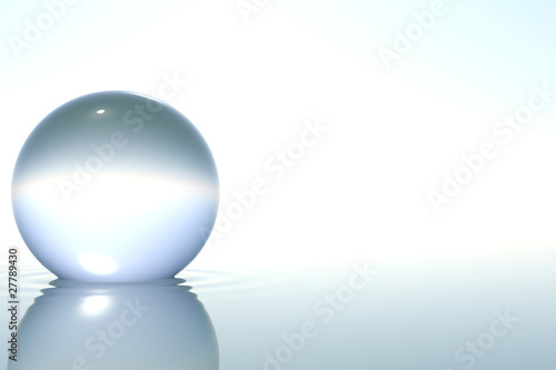 Zen glass sphere in water on white background