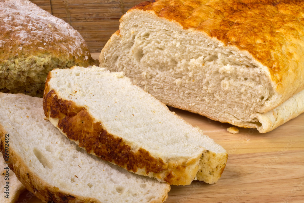 Homemade bread on a breadboard with a breadknife