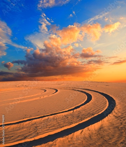 road in a sand desert at the evening