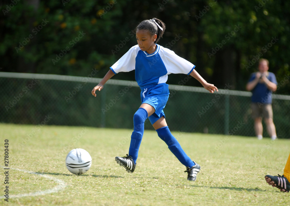 girl playing soccer