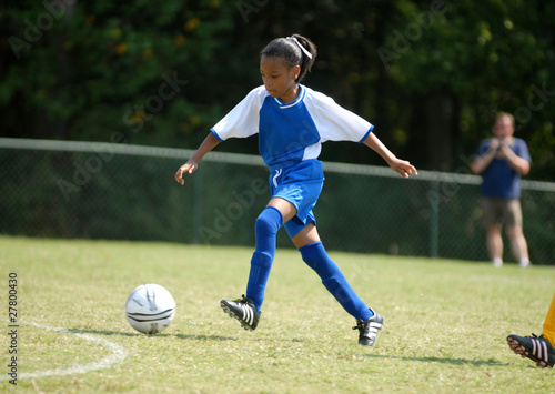 girl playing soccer © Isaiah Love