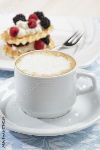 Cup of coffee and waffles with fruits