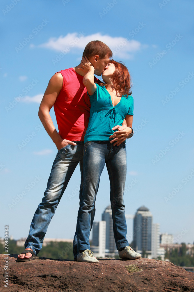 Young loving couple embraces and kisses Young loving couple embraces and kisses