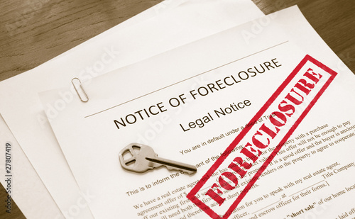 home foreclosure legal document with house key