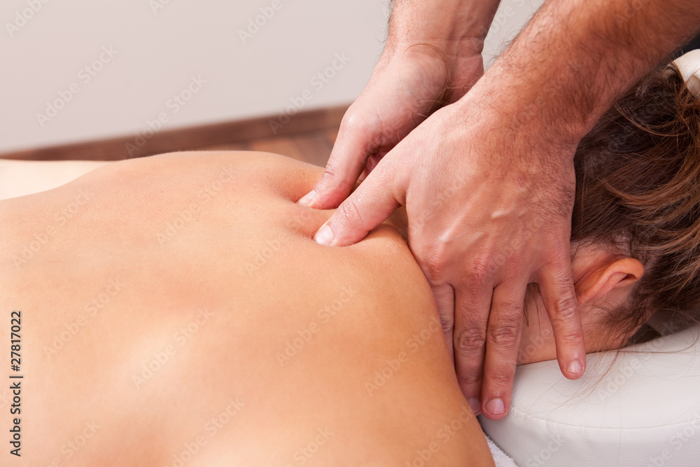 Fototapeta premium Young beautiful woman getting back massage