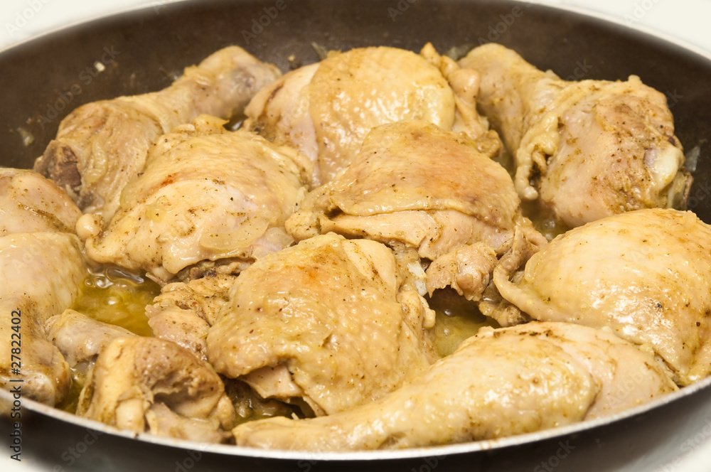 fried chicken cooking in pan against a white background fried chicken cooking in pan against a white background