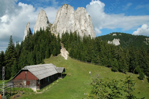Mountain landscape with an old wooden house
