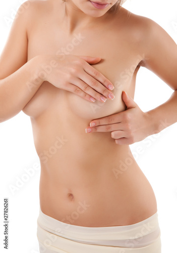 Woman examining her breast isolated on white