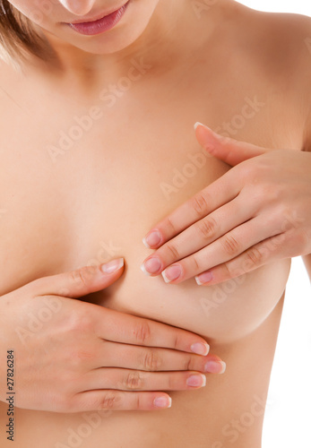 Woman examining her breast isolated on white