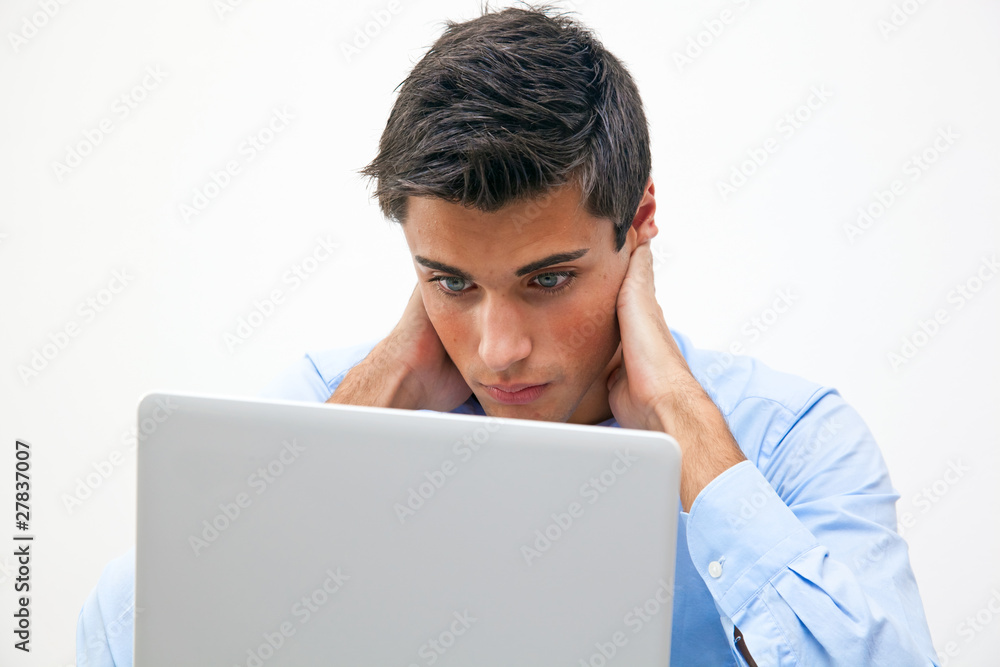 Thoughtful business man looking at his laptop Thoughtful business man looking at his laptop