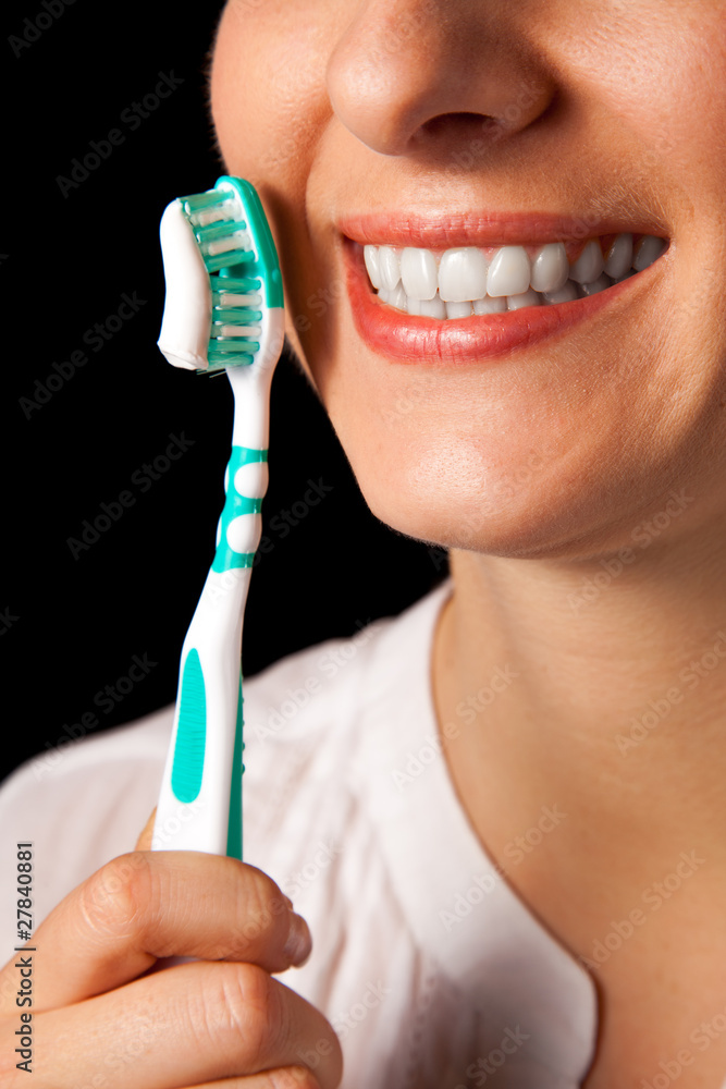 Woman healthy teeth closeup with toothbrush on black background Woman healthy teeth closeup with toothbrush on black background