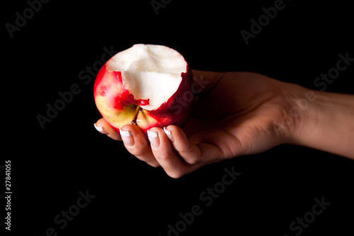 Woman holding red apple on black background