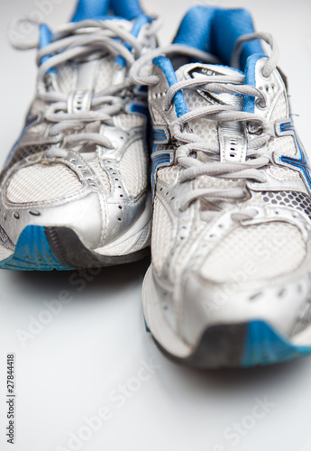 Pair of running shoes on a white background. (shallow DOF; color