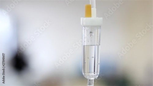 Intravenous drip on white background in operation room