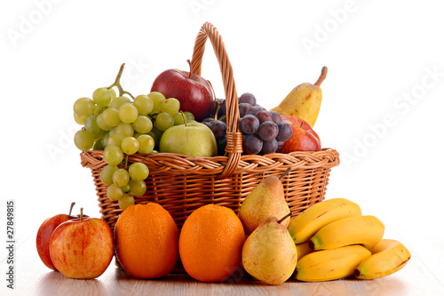 Composition with fruits and wicker basket isolated on white