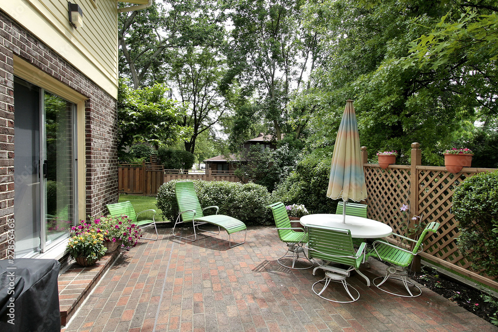 Patio with brick patio and green furniture