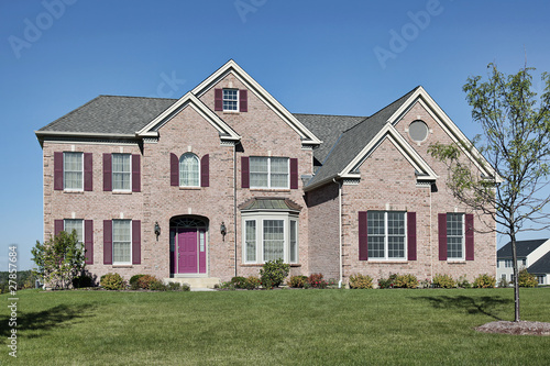 Brick home with pink door