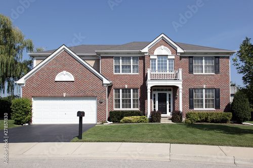 Luxury brick home with front balcony © pics721