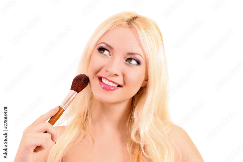 Young woman applying eye shadow, isolated on white