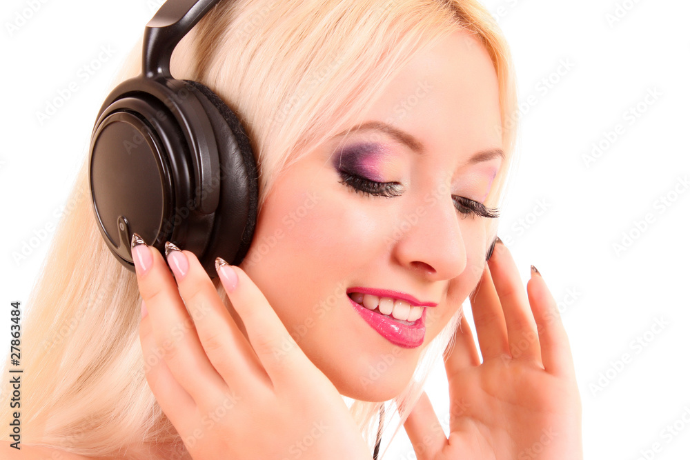 Beautiful young blonde woman with bright make-up listening music Beautiful young blonde woman with bright make-up listening music