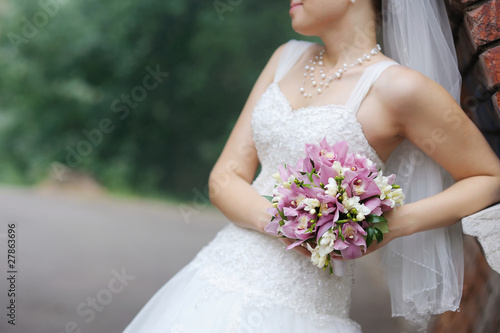 Bride holding pink wedding flowers bouquet