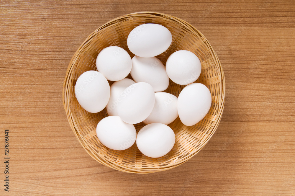 Many white eggs on the wooden table Many white eggs on the wooden table