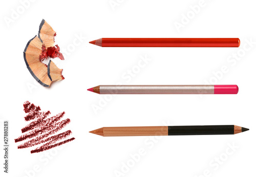 Cosmetic pencils sharpening with husk on white and stroke sample