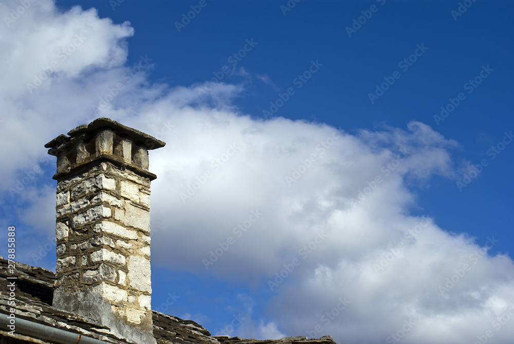 Old stone chimney and blue sky