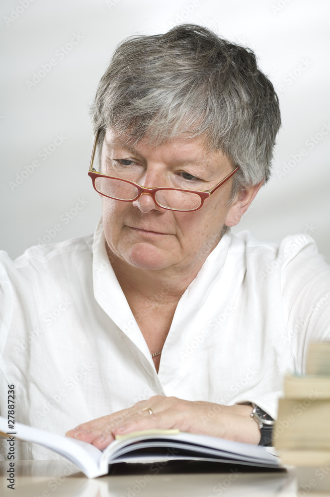 Adult women studying while reading a book