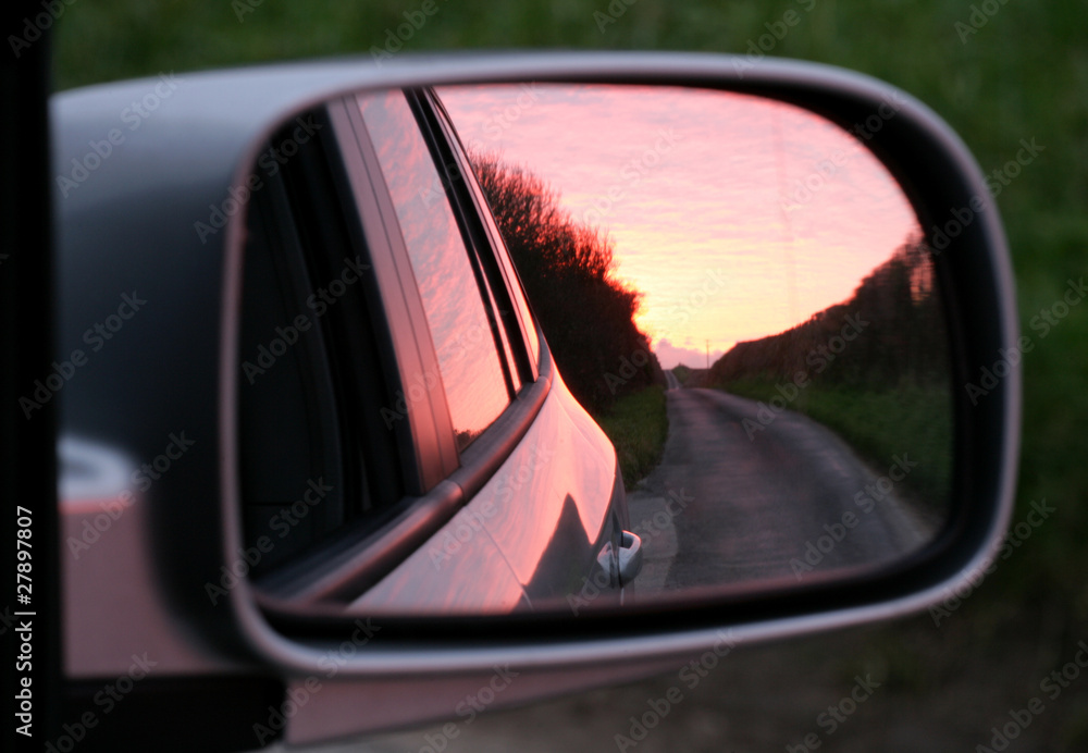 Pink sunset in rear view mirror Pink sunset in rear view mirror