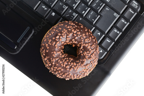 break in the  office . doughnut on laptop keyboard
