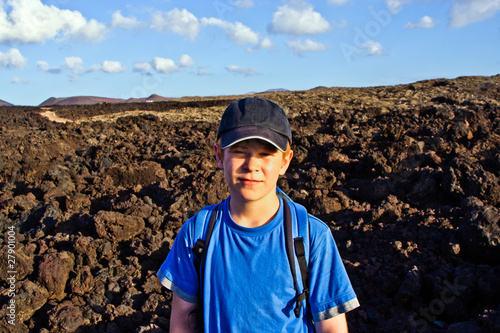 young boy walking through volcanic area in Lanzarote © travelview