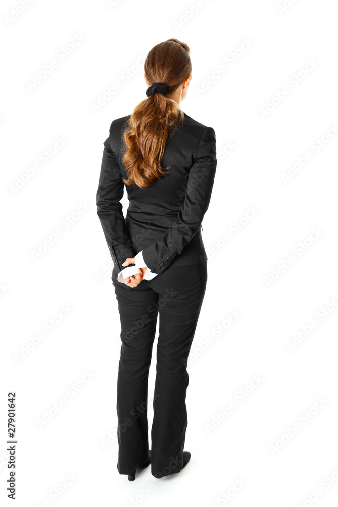 Modern business woman standing with her back to camera Modern business woman standing with her back to camera