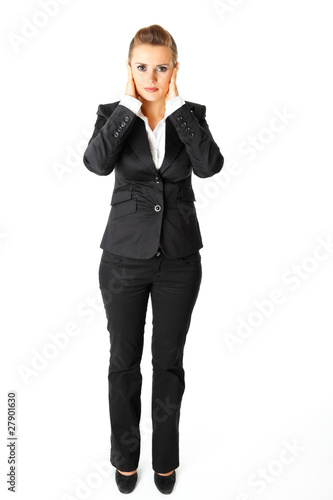 Modern business woman with hand on ears isolated on white.