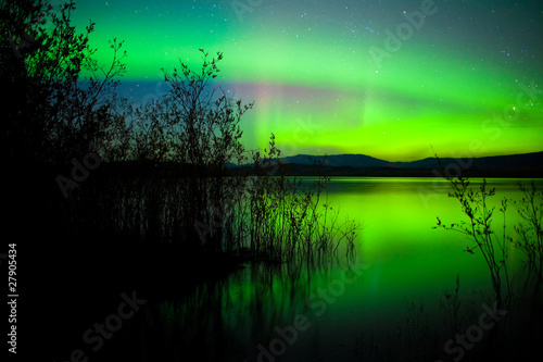 Northern lights mirrored on lake