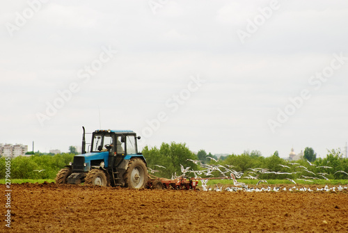 The tractor ploughs an agricultural field