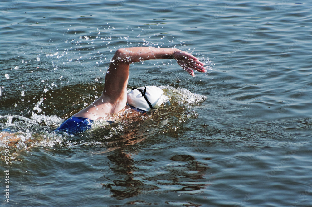 The girl sportswoman floats in pool water