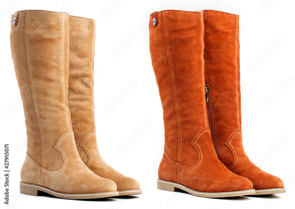 Two pairs of female high boots on the white background Two pairs of female high boots on the white background