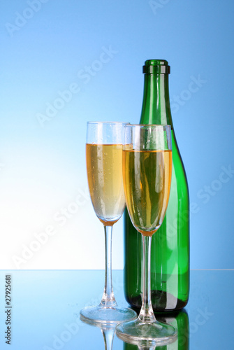 Glass with champagne on blue background