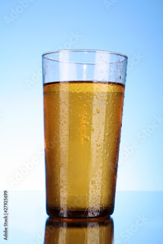 Cup of beer on blue background