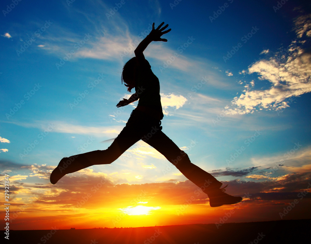 Young woman jumping with raised hands Young woman jumping with raised hands