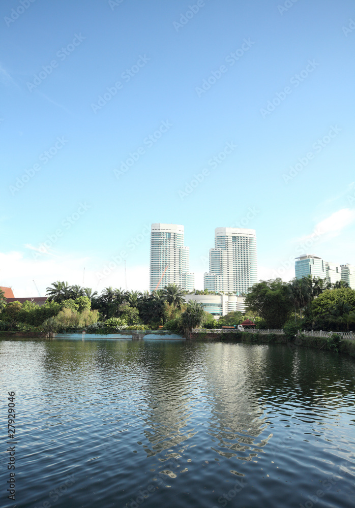 Buildings of a city with reflection in the water. Kuala Lumpur