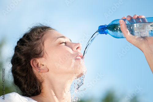 Beautiful woman drinking water. Thirst