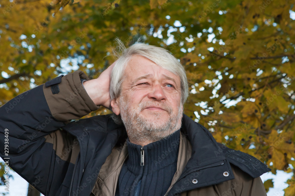Portrait of middle-aged man in autumn day. Portrait of middle-aged man in autumn day.