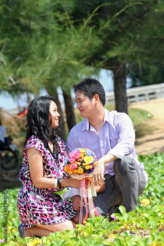 lovely couple make eye contact on the grass beach lovely couple make eye contact on the grass beach